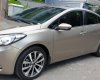 Kia K3 1.6 AT  2013 - Bán Kia K3 1.6 AT số tự động model 2014, Sx 2013, màu vàng 1 đời chủ mới 90%