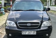 Cần bán xe Kia Carnival 2.5AT đời 2009, màu đen giá 299 triệu tại Tp.HCM
